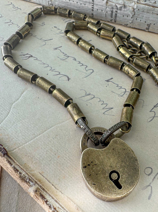 Bronze padlock necklace on an old letter